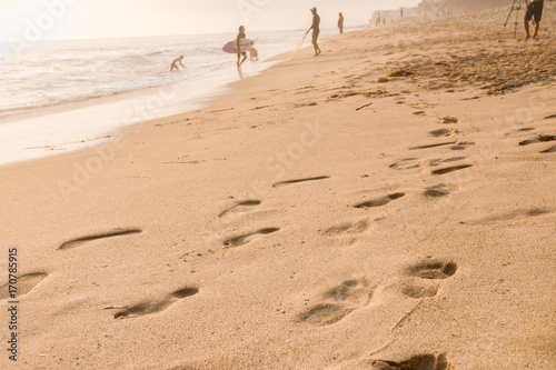 Footprints in the sand at golden hour