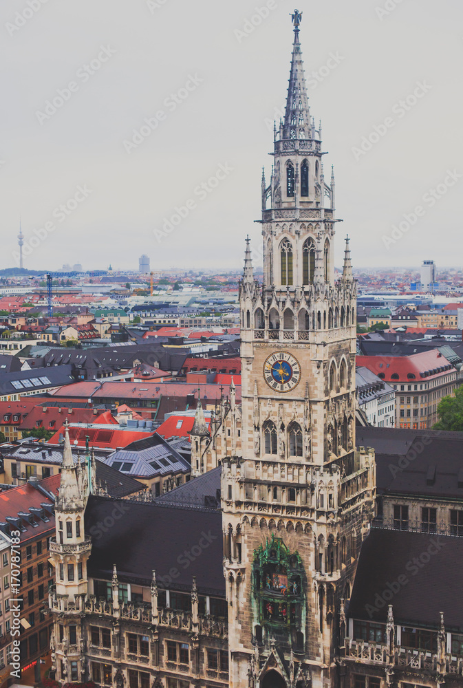 Fototapeta premium Beautiful super wide-angle sunny aerial view of Munich, Bayern, Bavaria, Germany with skyline and scenery beyond the city, seen from the observation deck of St. Peter Church