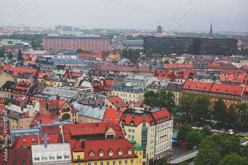 Beautiful super wide-angle sunny aerial view of Munich, Bayern, Bavaria, Germany with skyline and scenery beyond the city, seen from the observation deck of St. Peter Church
