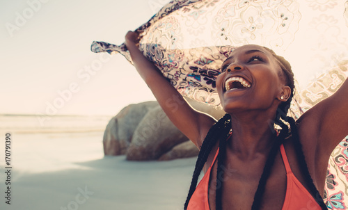 Fotografia, Obraz Laughing woman with scarf on beach
