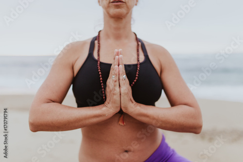 women doing yoga exersices on the beach photo