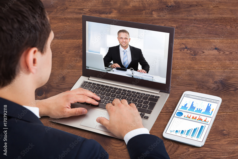 Businessperson Video Conferencing With Male Colleague Businessperson Video Conferencing With Male Colleague