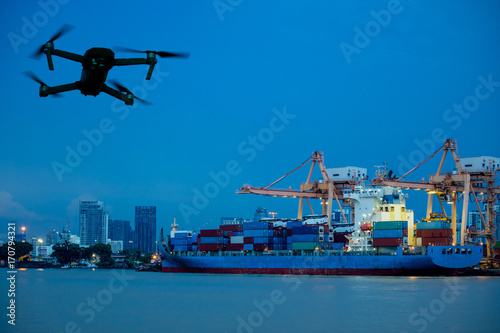 Wallpaper Mural Drone/Quadcopter with camera flying on container cargo ship at shipping port. double exposure Torontodigital.ca
