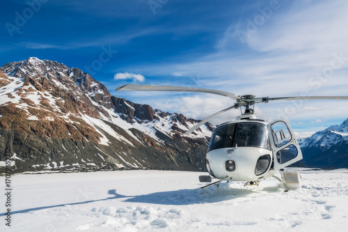 Helicopter Landing on a Snow Mountain photo