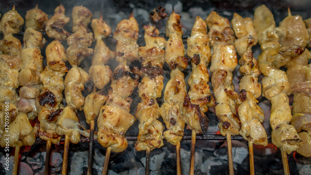 traditional indonesian cuisine chicken satay; chicken skewer with bamboo stick grilled on charcoal