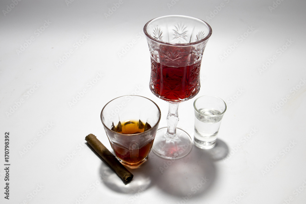 liquor and cigar in glass on isolated white background liquor and cigar in glass on isolated white background