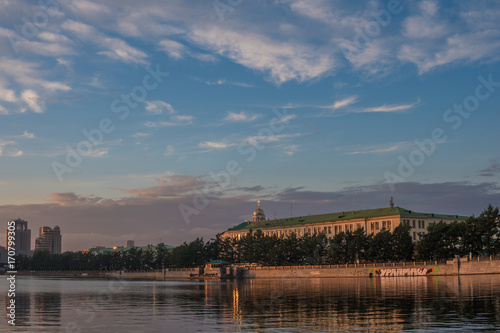YEKATERINBURG, RUSSIA - 1 JULY, 2017: Quay city pond, Sevastyanov's house at sunset time