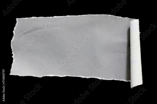 Torn white paper with a black background