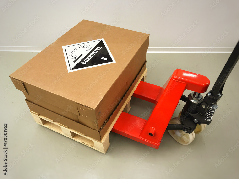 Hazardous delivery pallet and manual pallet truck. Stock Photo Adobe