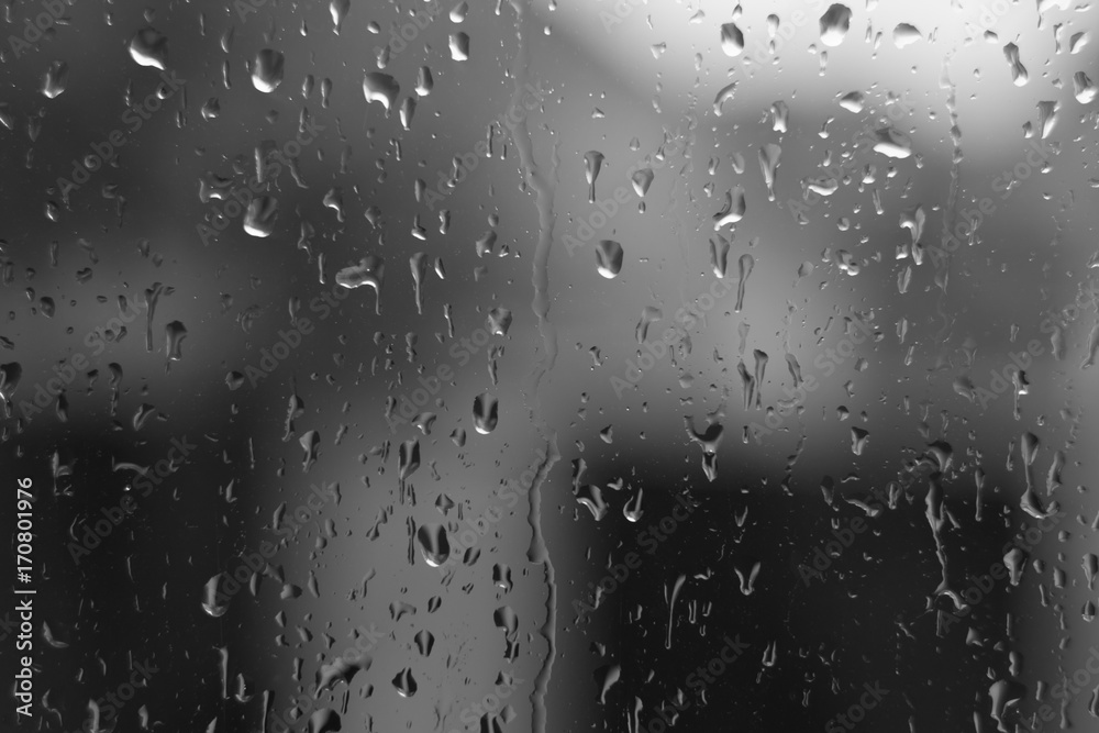 Water drops on house window with blur background.