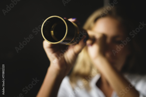 Caucasian woman using telescope spyglass photo