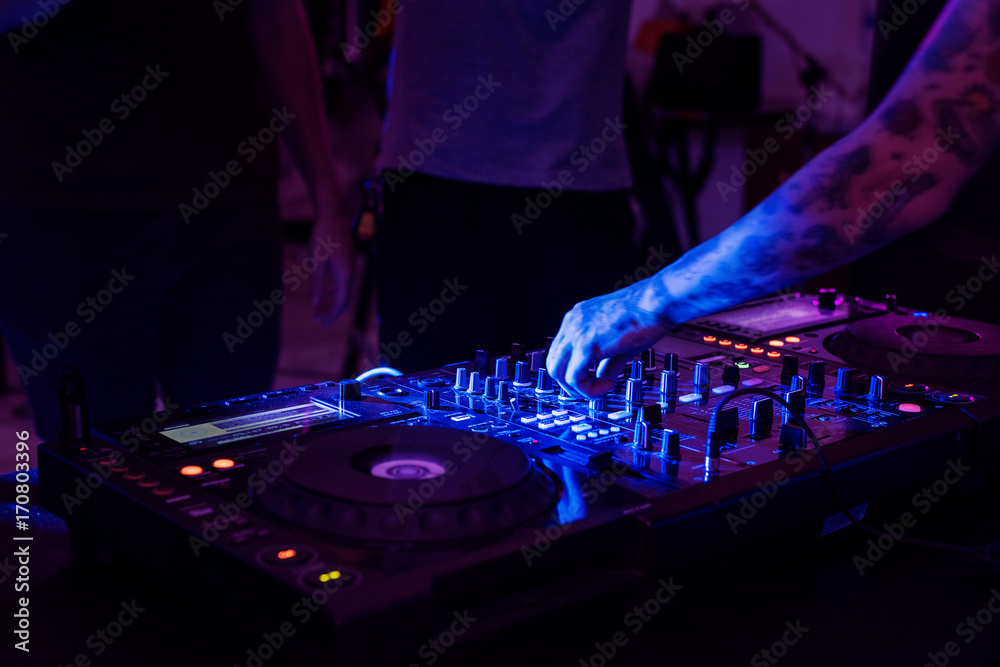 Obraz premium Hand on a sound mixer in a party