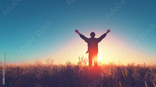 Man with his hands raised in the sun