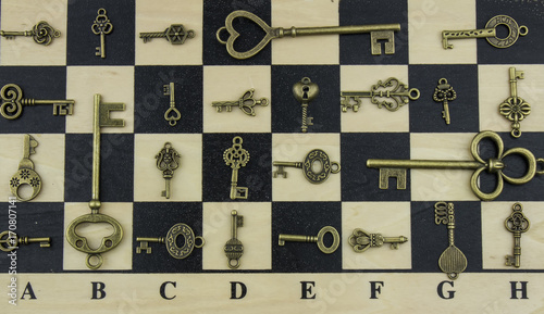 Ancient keys and chessboard photo