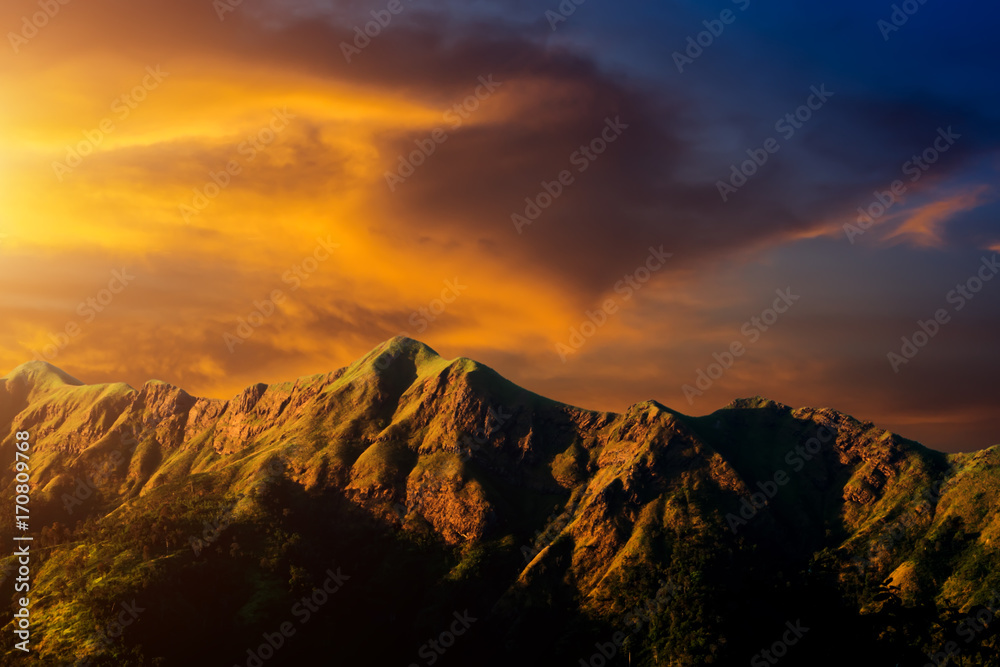Big mountain in the summer with orange cloud