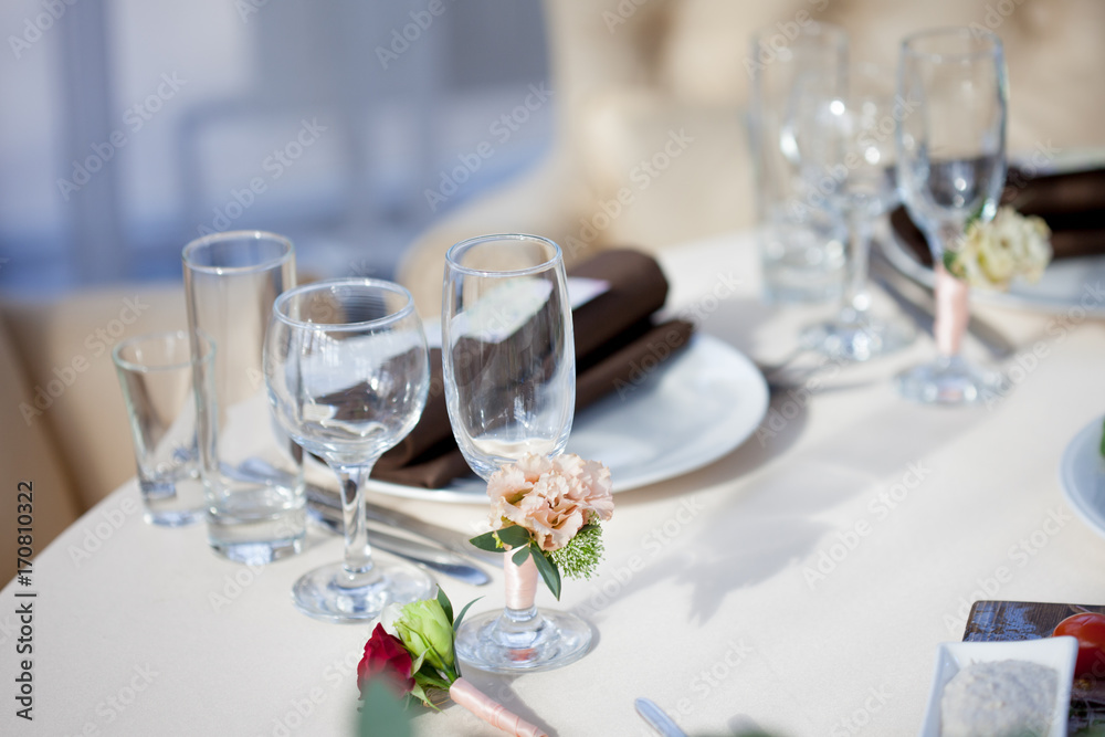 Table setting in the restaurant. floral decor on the glasses, wedding Table setting in the restaurant. floral decor on the glasses, wedding