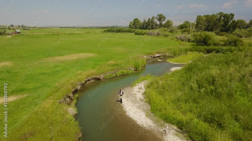 Aerial view of fly fisherman fishing in Montana river Aerial view of fly fisherman fishing in Montana river