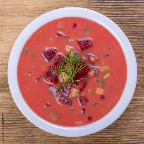 Cold borscht - speciality for hot summer days. Vegetable cold soup with beet, cucumber, potato, radsih and egg . Close up photo