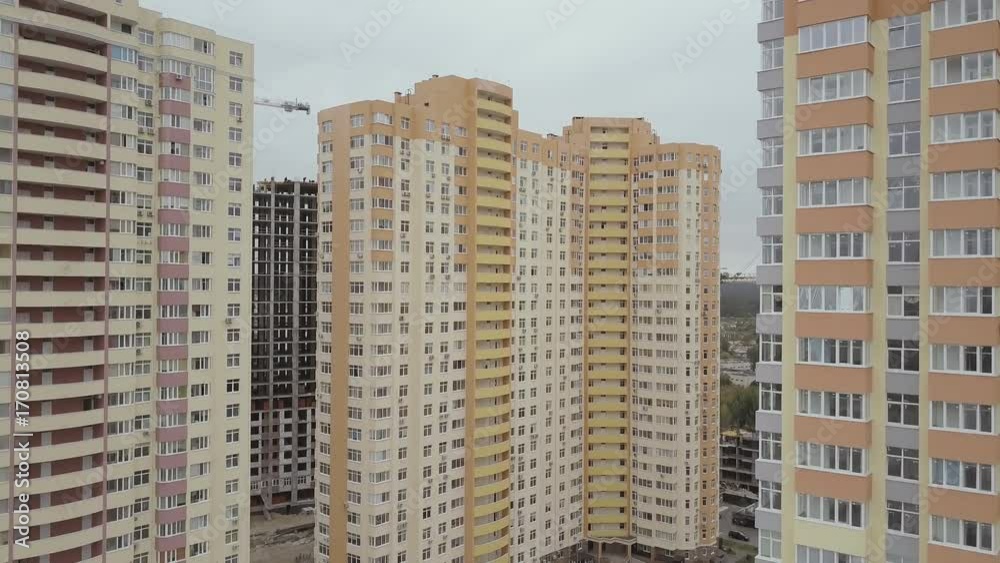 Aerial view. A complex of new high-rise apartment buildings in the city. The camera goes down Aerial view. A complex of new high-rise apartment buildings in the city. The camera goes down