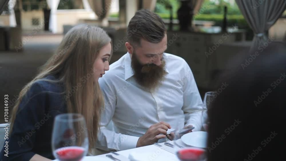 Feast. friends drink wine in a restaurant