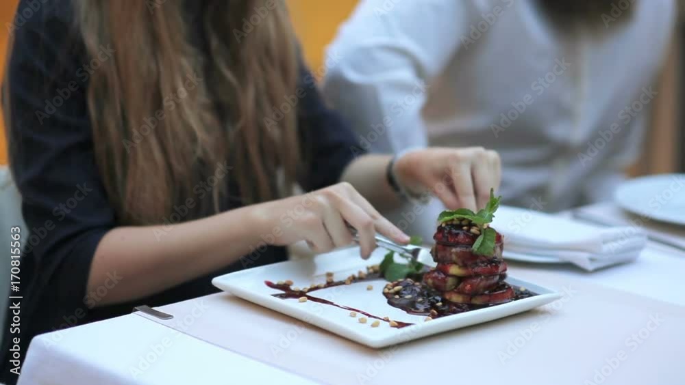 Girl tastes foie gras with sauce