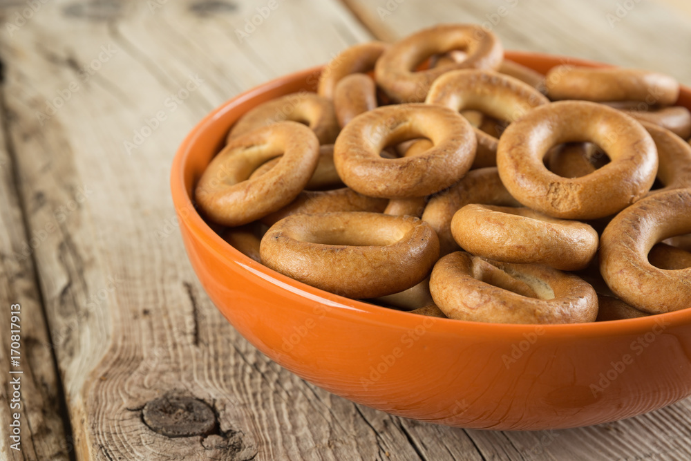 Bagels in a bowl on an wooden table