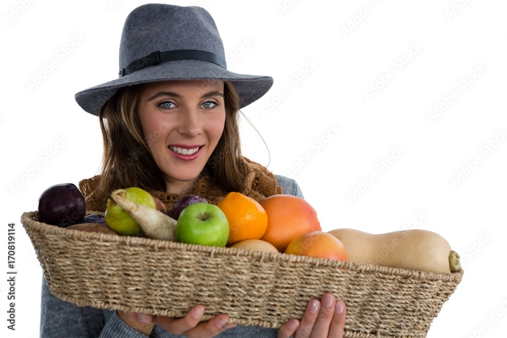 Portrait of young woman holding vegetables in wicker basket Portrait of young woman holding vegetables in wicker basket