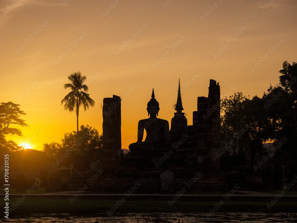 Silhouette Buddha Pagoda landscape sunset at Sukhothai Historical Park World heritage Thailand