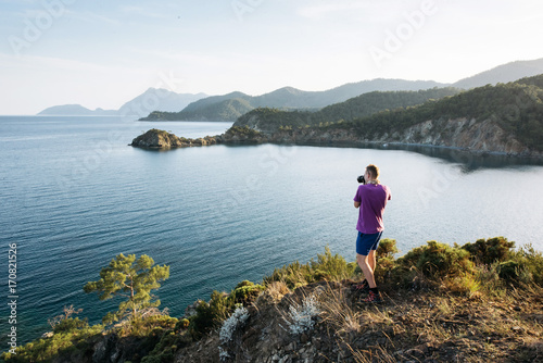 Tourist admiring the blue Mediterranean sea on the Turkish coast in the evening