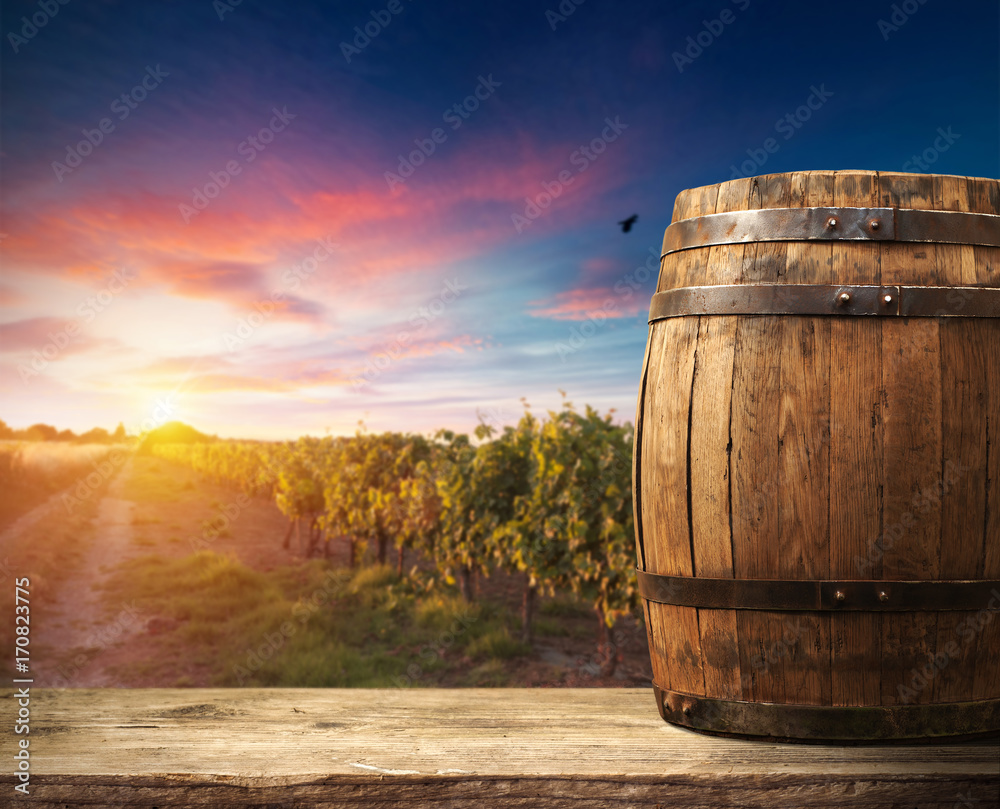 Red wine with barrel on vineyard in green Tuscany, Italy Red wine with barrel on vineyard in green Tuscany, Italy