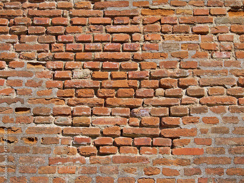 Old weathered brick wall closeup texture.