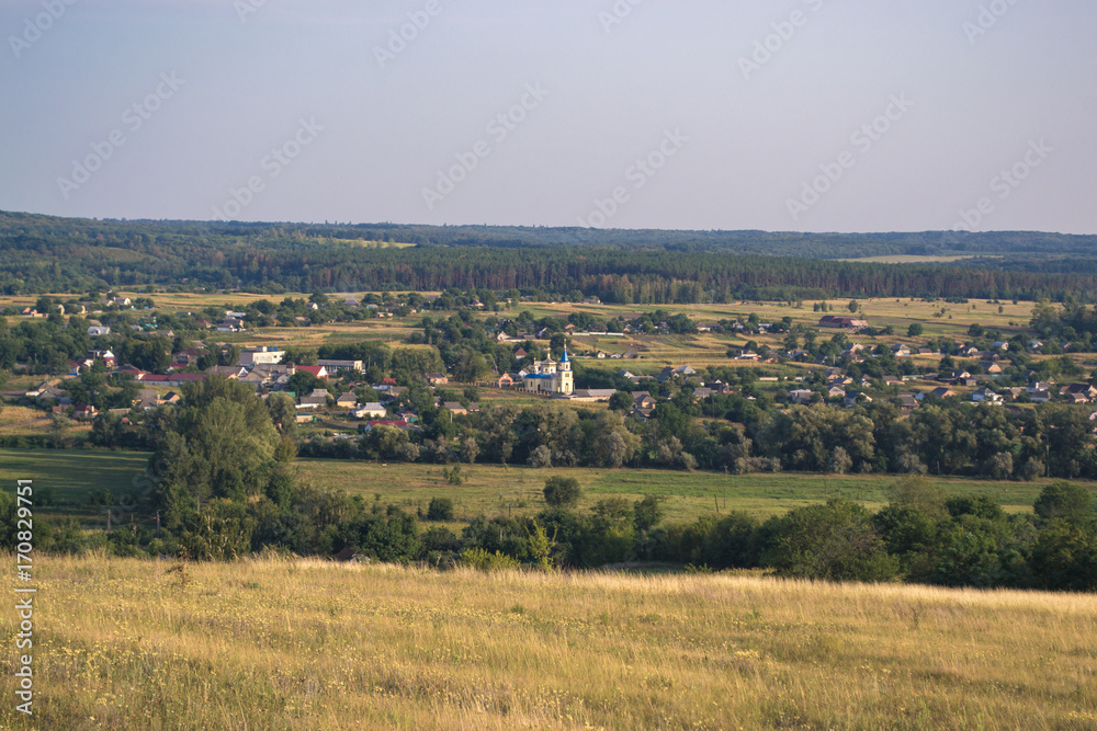 Summer sunny landscape at sunset of the day outside the city.