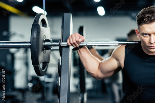 sportsman lifting barbell