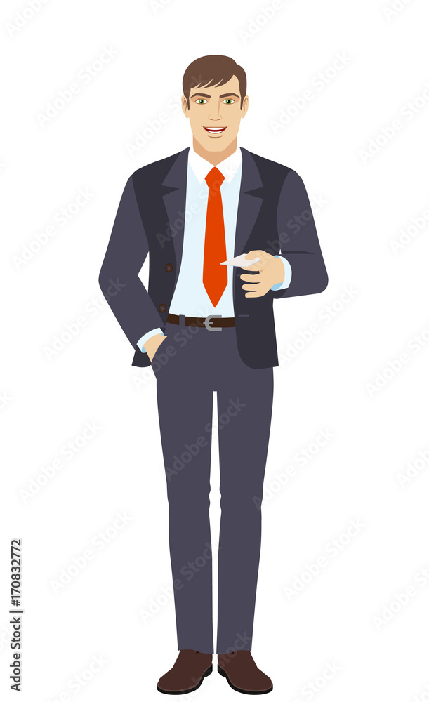Businessman with hand in pocket gives a business card