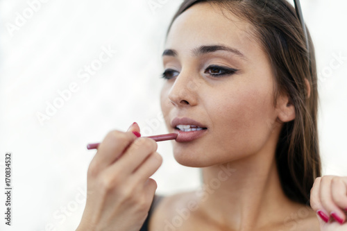 Beautiful woman doing make-up