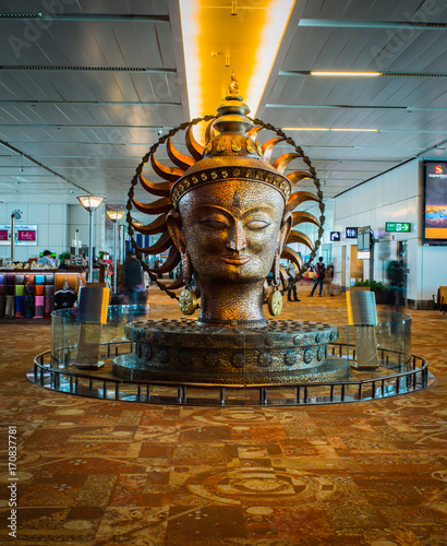 The big golden statue in international Airport of Delhi and crowd. Indira Gandhi International Airport is the 32th busiest in the world.
