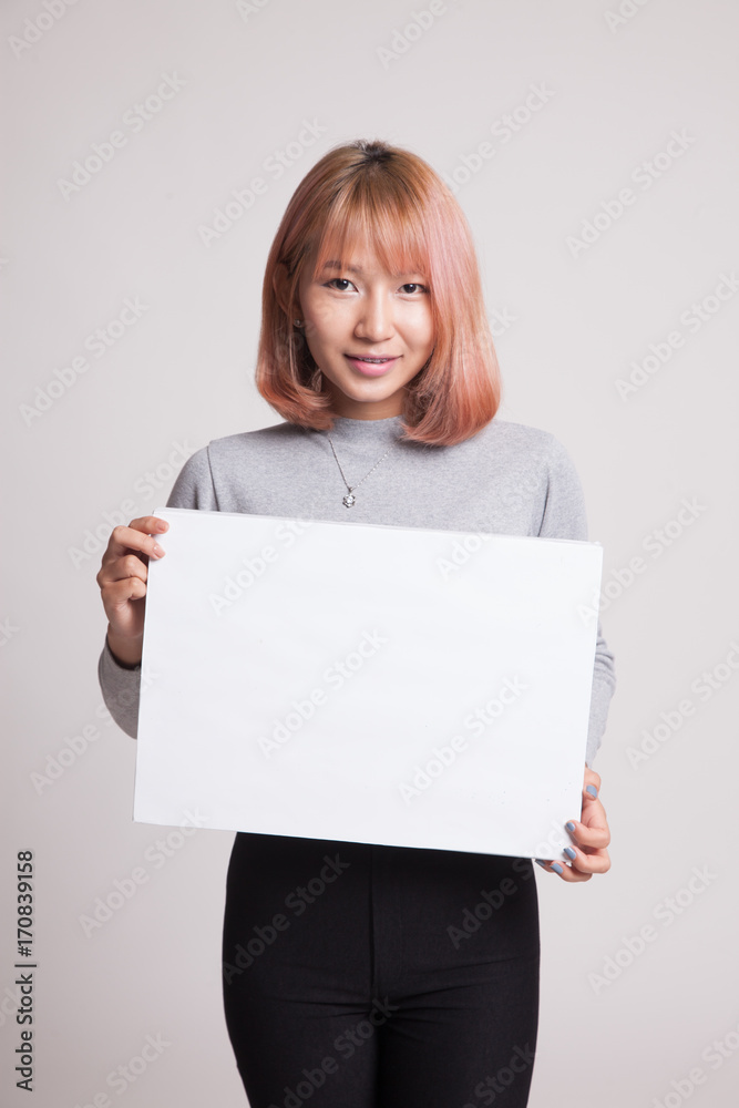 Young Asian woman with white blank sign. Young Asian woman with white blank sign.