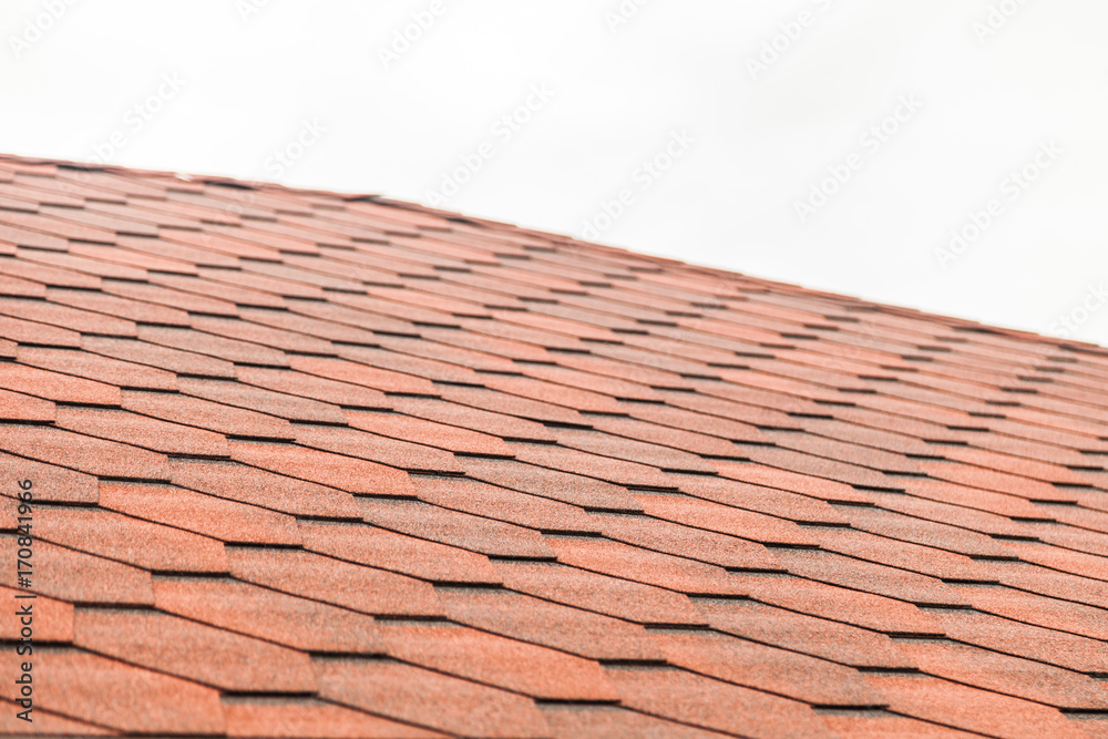Red roof tiles or shingles on house. On white background with selective focus