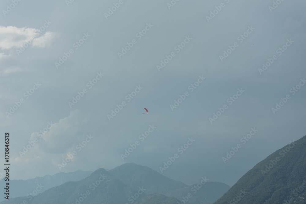 paragliding above lake water in front of mountain paragliding above lake water in front of mountain
