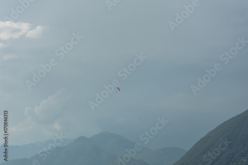 paragliding above lake water in front of mountain