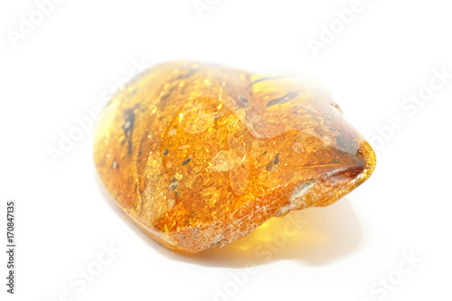 Extraordinarily beautiful transparent yellow amber on a white background. Natural mineral fossil resin bright yellow color with patterns inside. Jewelry stone Baltic amber. Amber texture