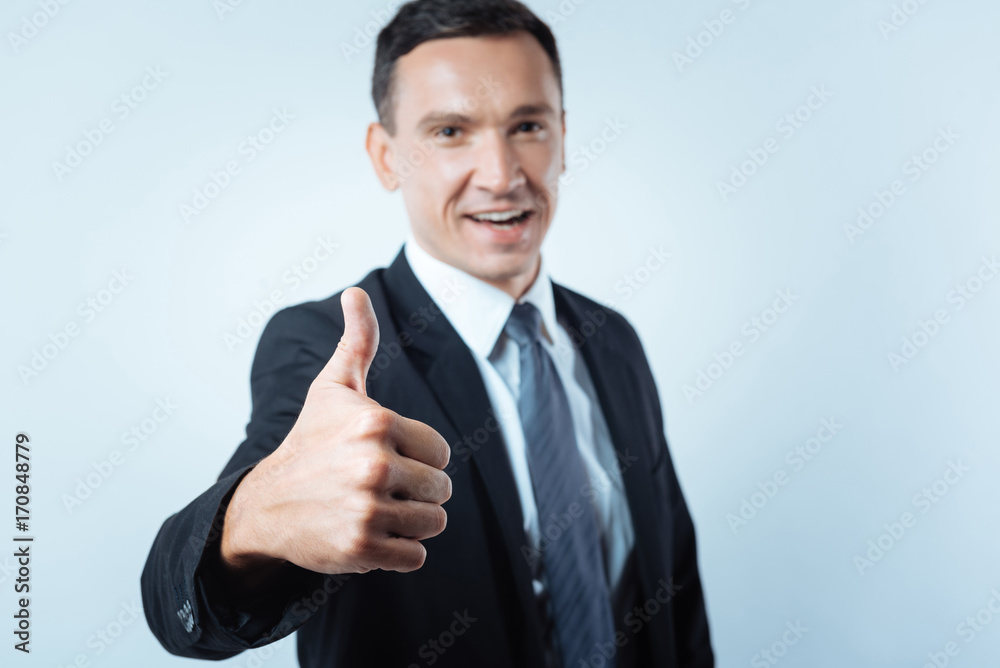Selective focus of a hand showing thumbs up gesture Selective focus of a hand showing thumbs up gesture