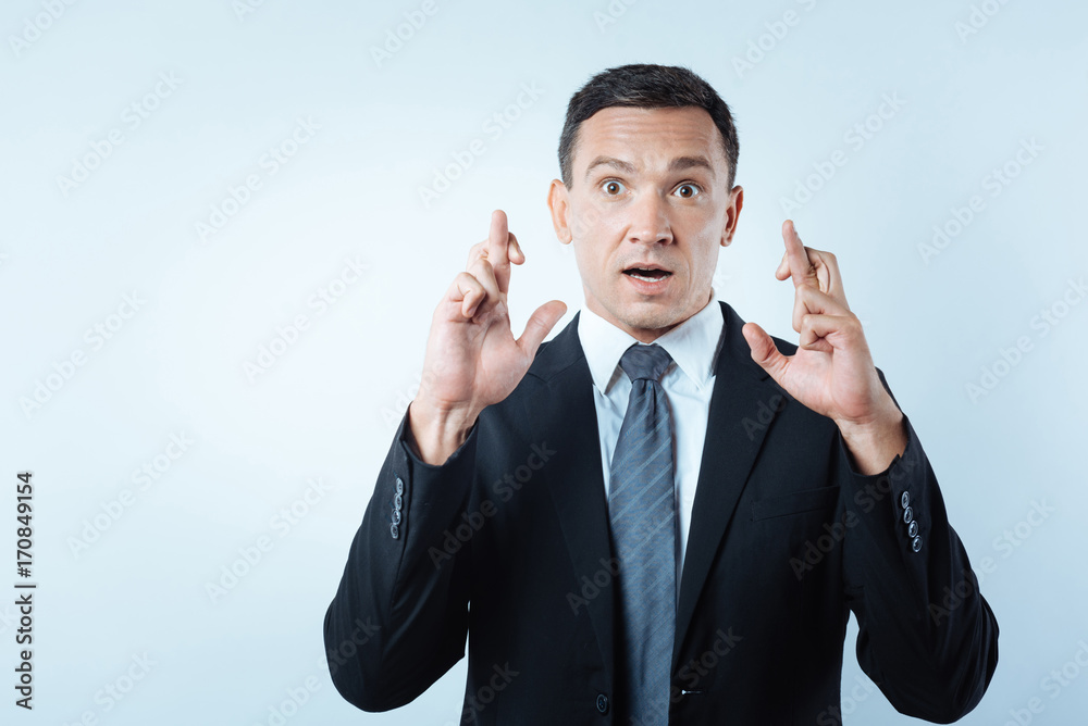 Pleasant good looking man believing in superstitions Pleasant good looking man believing in superstitions