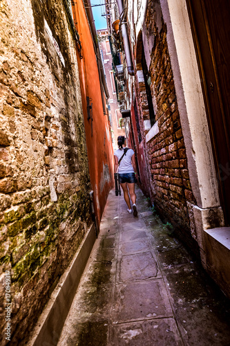 Woman walks through the narrow streets of Venice