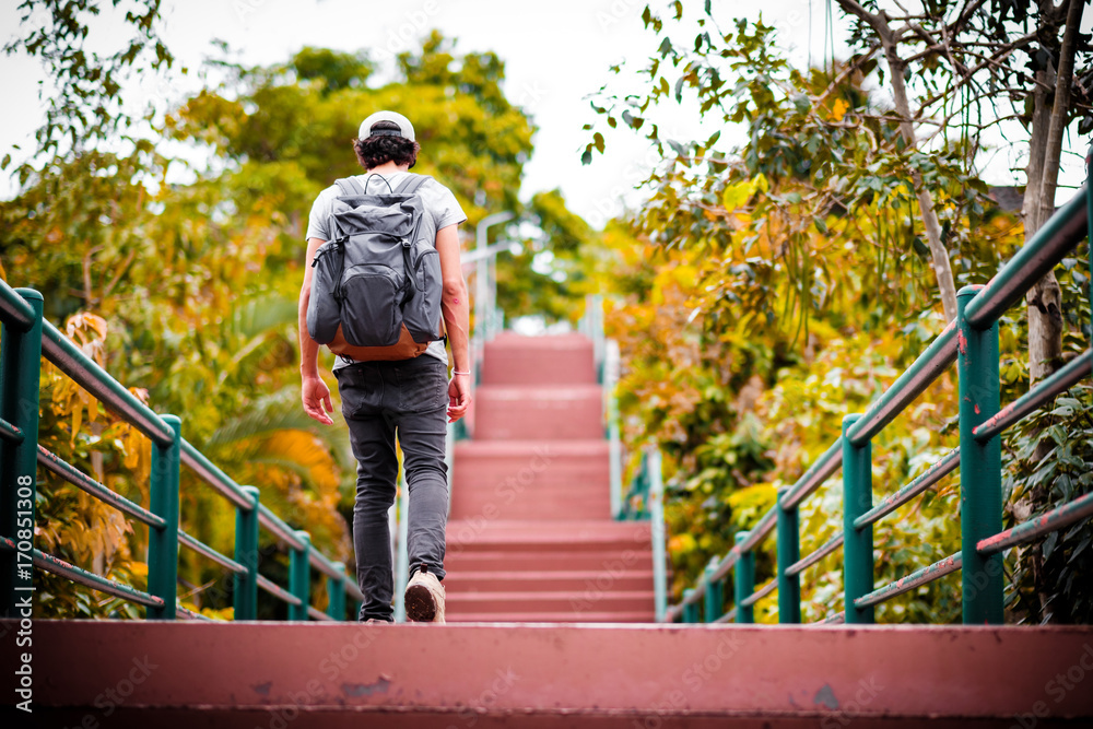 man traveling walking with backpack at national park in the jungle day time sun shine on holiday at weekend relax fresh on background nature view man traveling walking with backpack at national park in the jungle day time sun shine on holiday at weekend relax fresh on background nature view