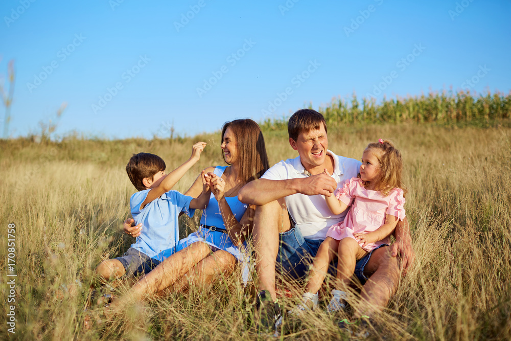 Happy family in nature plays smilling and laughs.