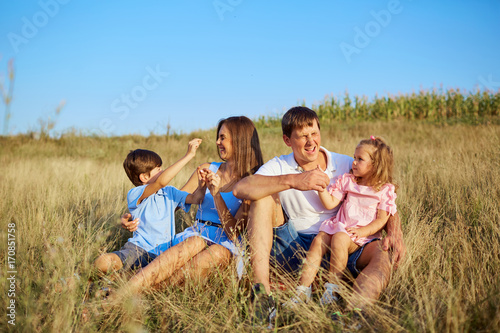 Happy family in nature plays smilling and laughs. © Studio Romantic