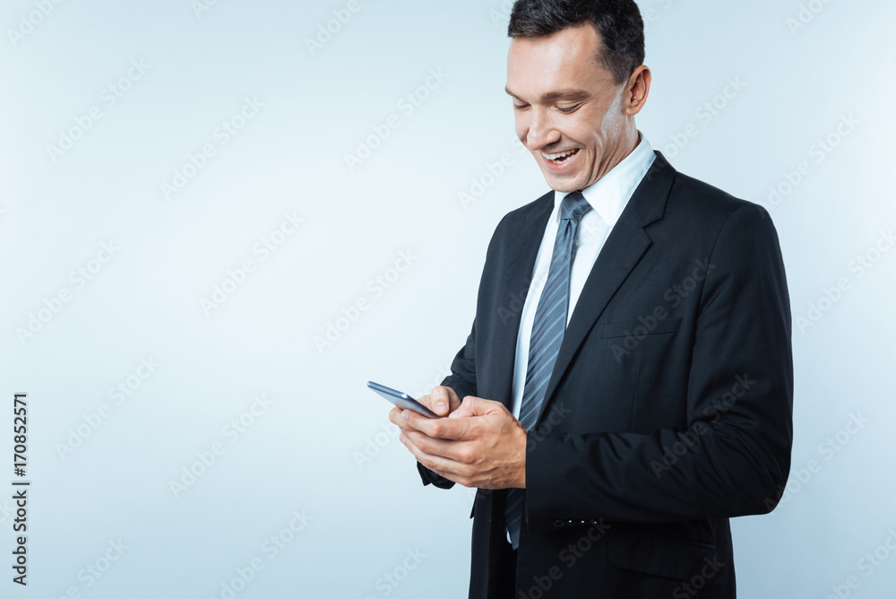 Joyful happy businessman typing a message Joyful happy businessman typing a message