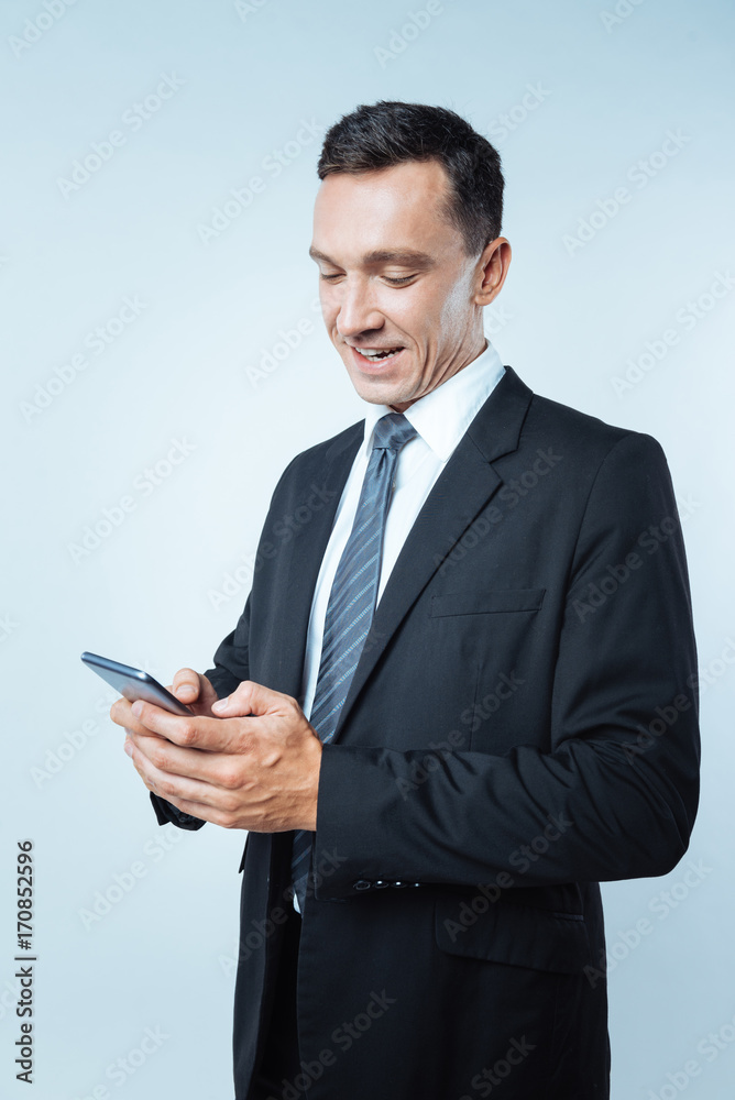 Delighted positive businessman talking online