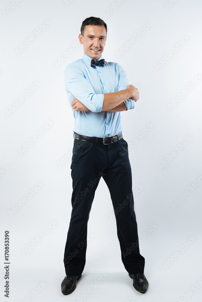 Delighted attractive man crossing his arms Delighted attractive man crossing his arms